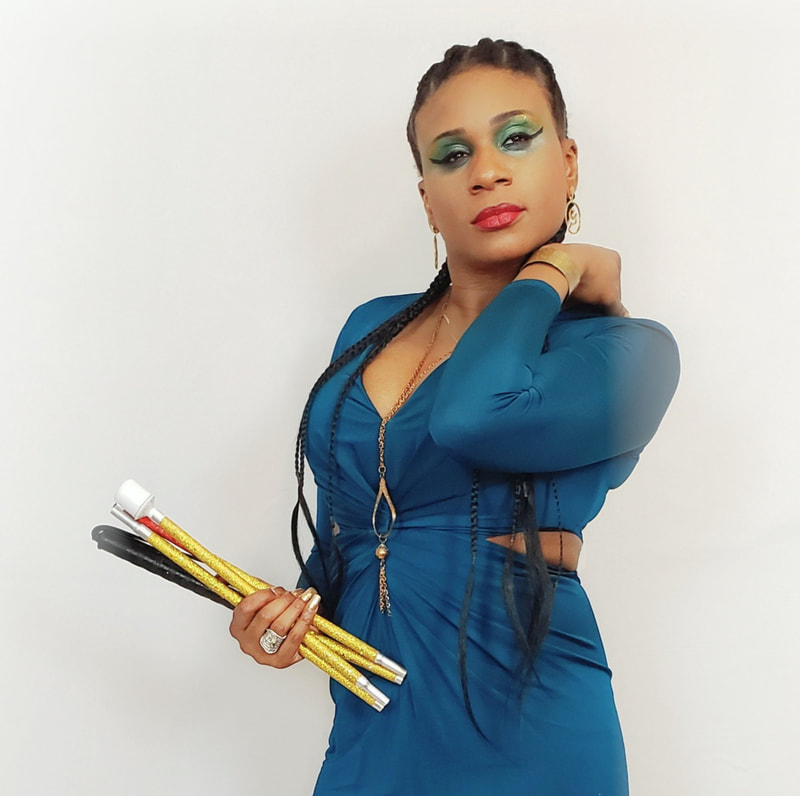 Lachi with cornrows, green dress and green glamcane cane , black blind disability female edm singer, actress